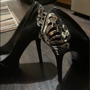Black suede style shoe heels with silver metal butterflies on the back